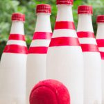 Bowling pins made out of bottles and a tennis ball