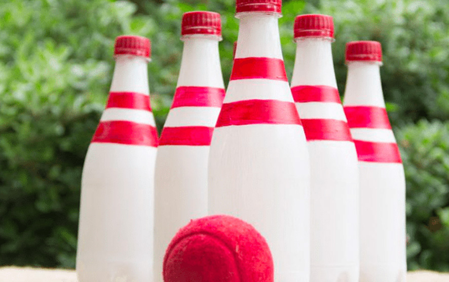 Bowling pins made out of bottles and a tennis ball