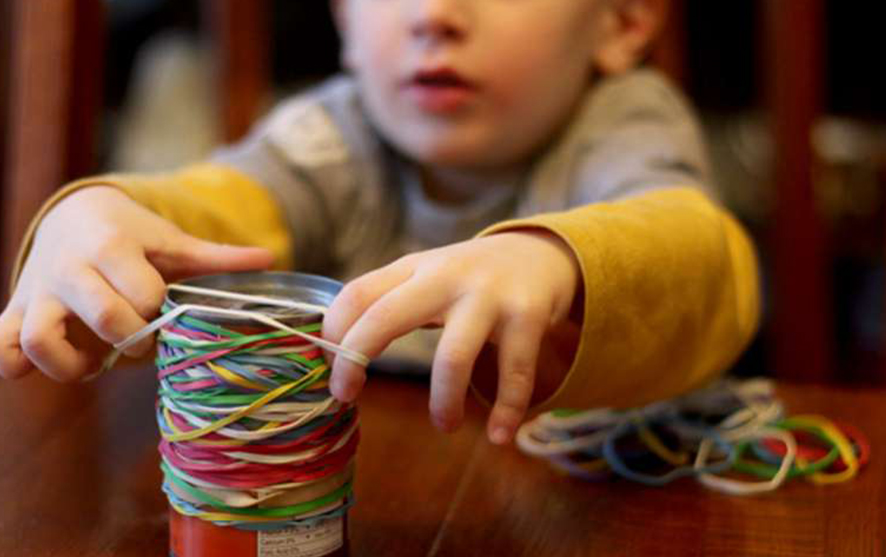 A child playing with rubber bands