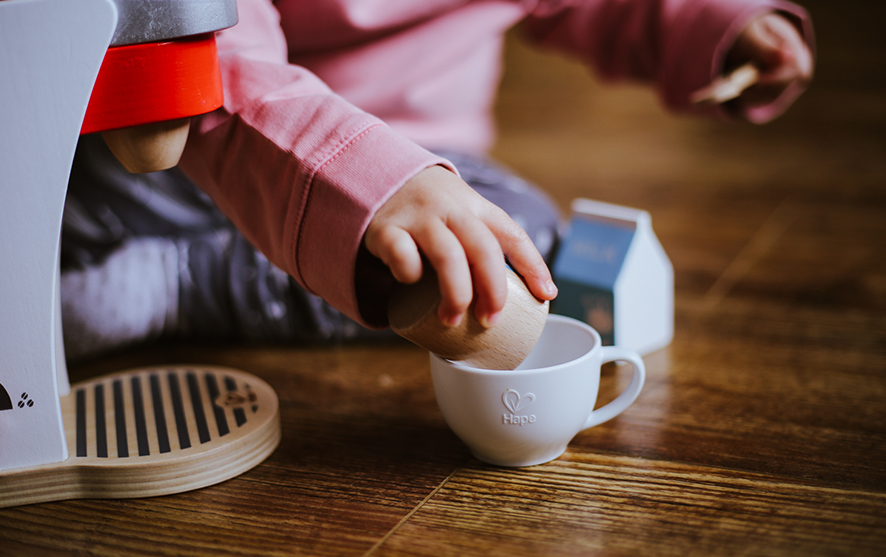 A child playing with coffee cups