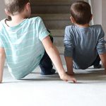 Two children practicing a crab walk