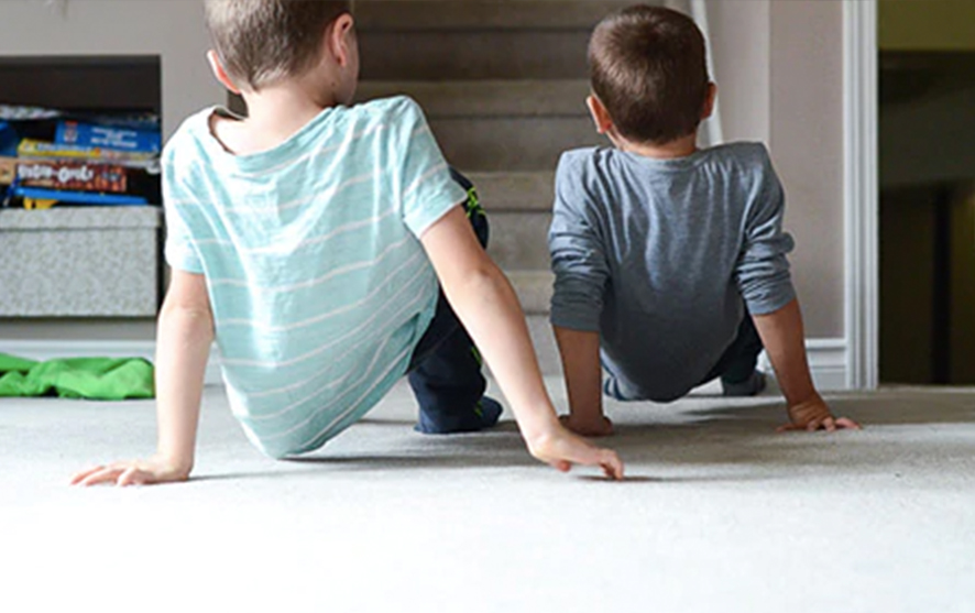 Two children practicing a crab walk