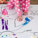 A child painting an outline of a person