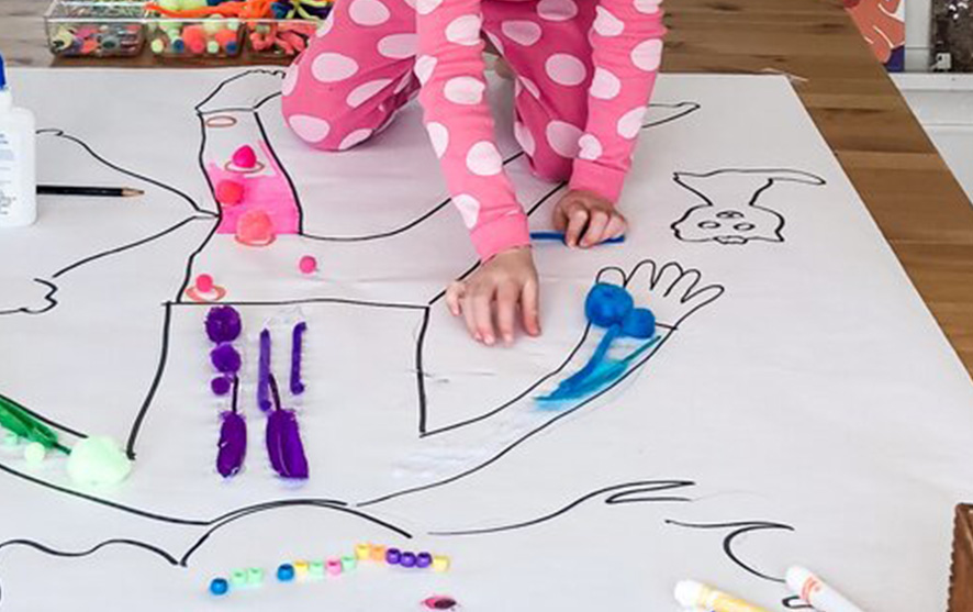 A child painting an outline of a person