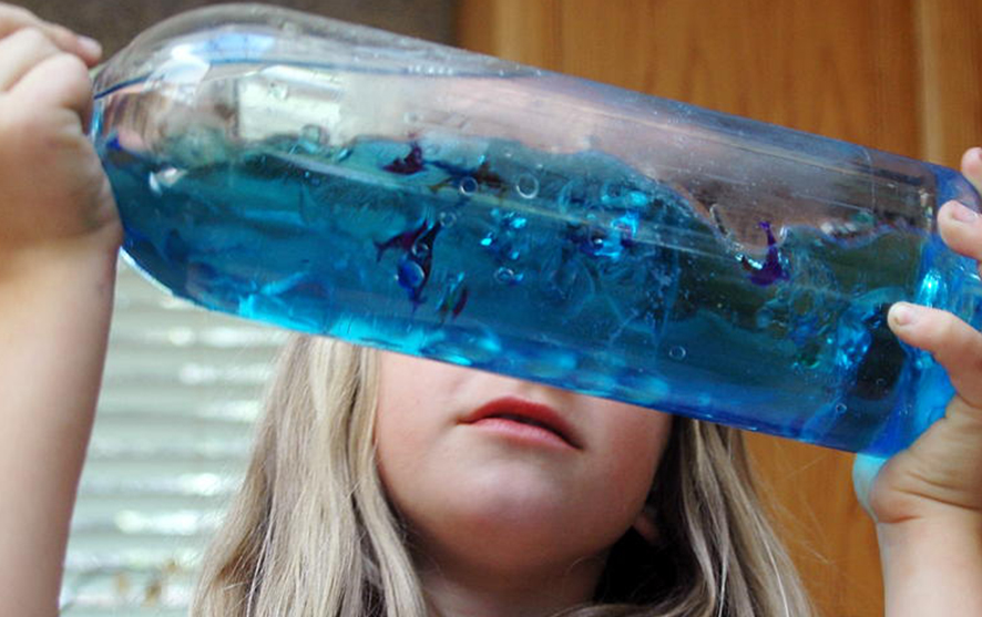 A girl holding a blue ocean bottle