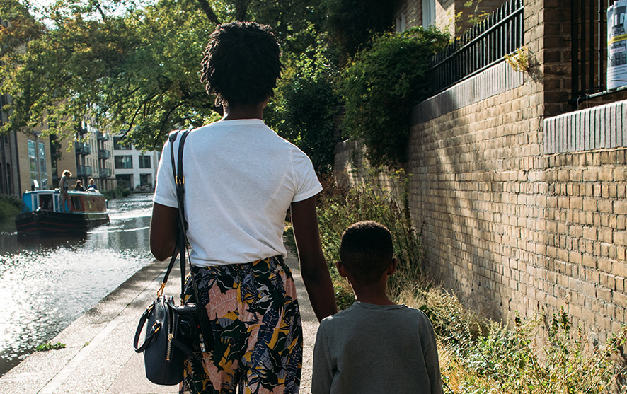 A woman and a child walking down the street