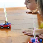 Children playing wind race cars