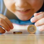 A child playing with coins