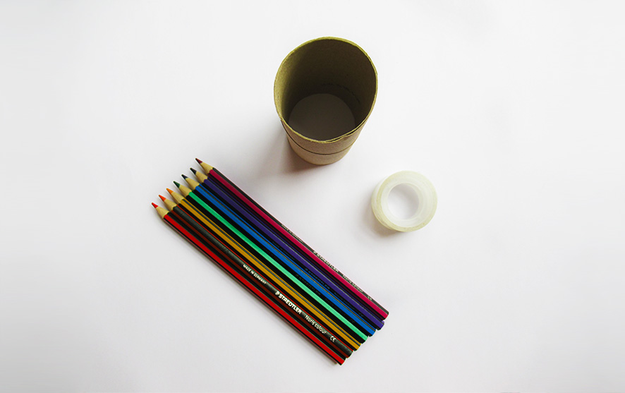 Pencils, duct tape and cardboard on a white surface