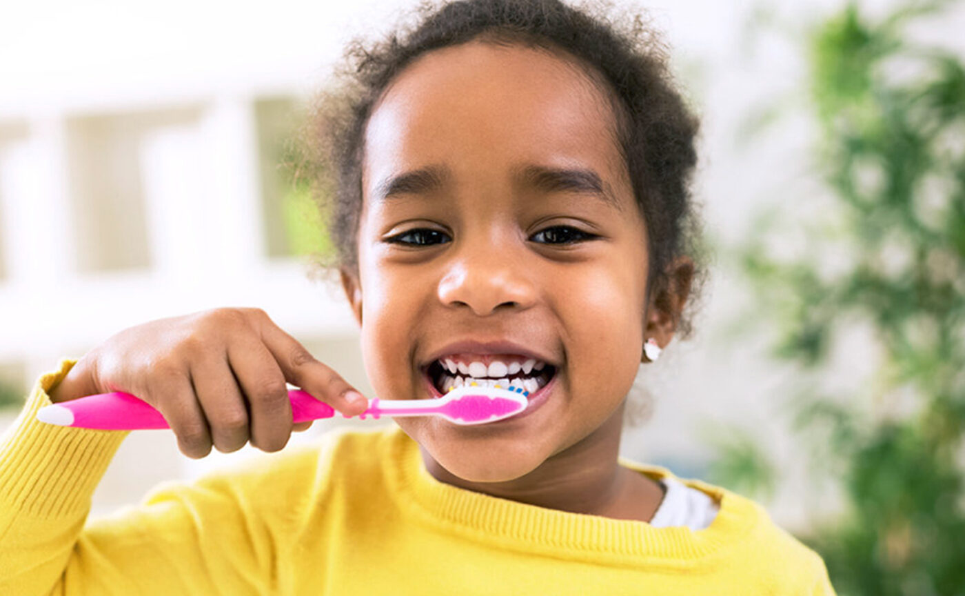 A little girl brushing her teeth