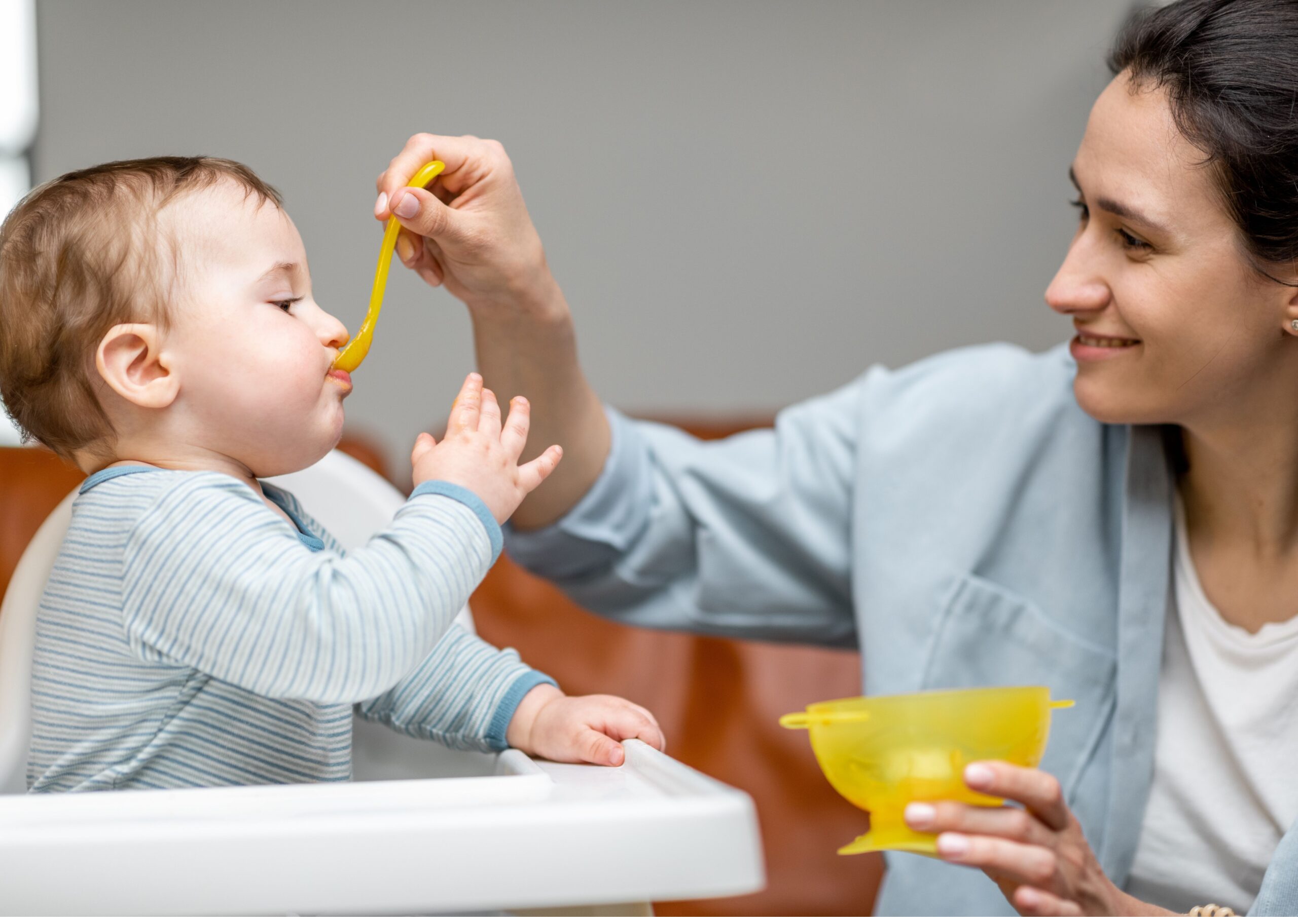 Mom spoon feeding her baby