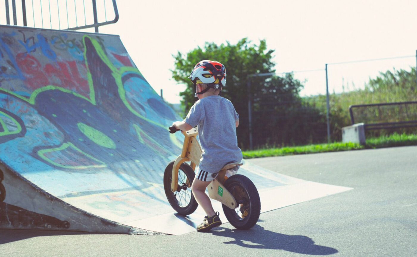 A little boy learning how to ride a bike