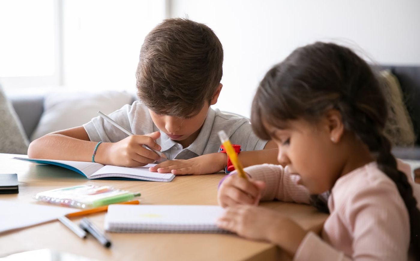 Two children practicing writing