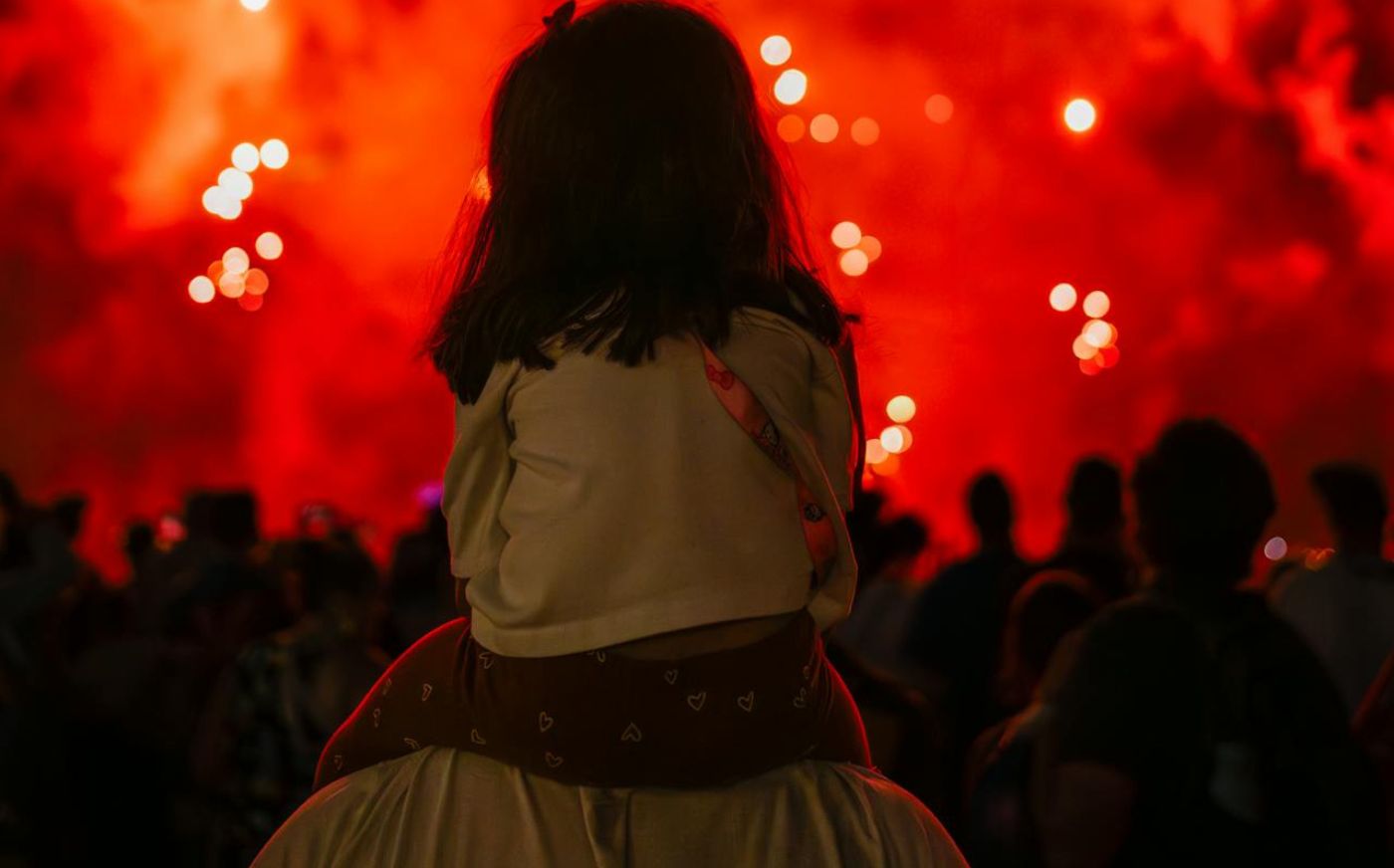 Bonfire night - child sitting on parent's shoulders