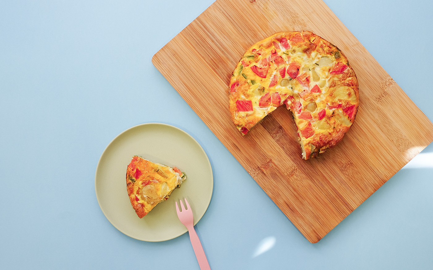 Spanish tortilla with roasted tomatoes and spinach and herb salad